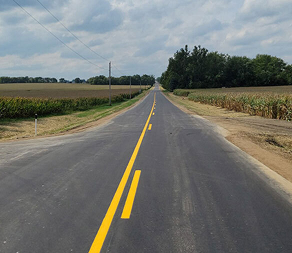 Highway with corn fields on either side